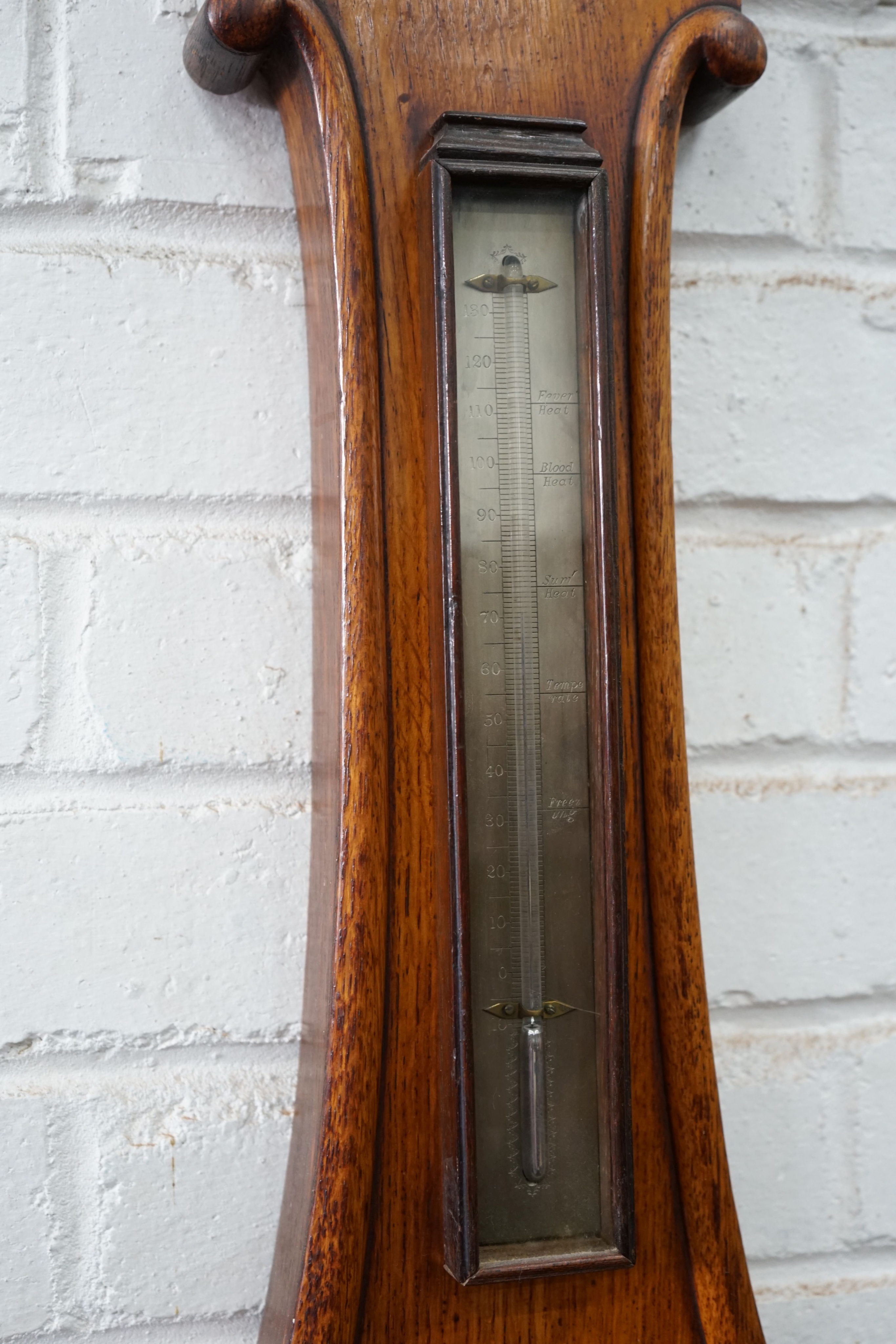 A Victorian oak wheel barometer, height 104cm
